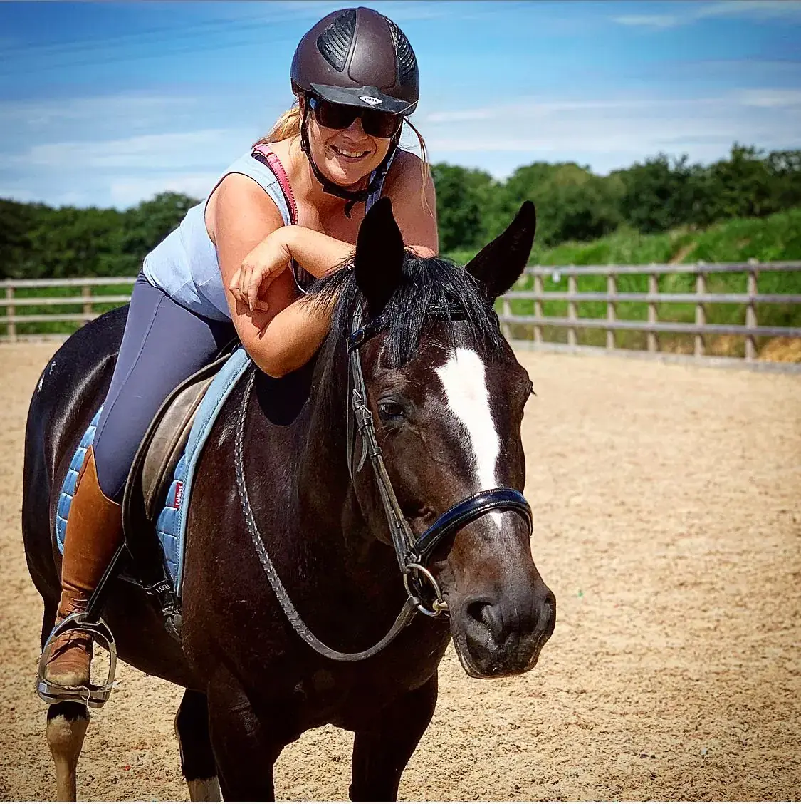 A rider sharing a happy moment with her horse